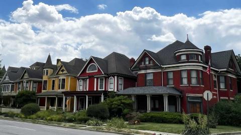 Several Victorian style homes along a street in Herron-Morton Place neighborhood.